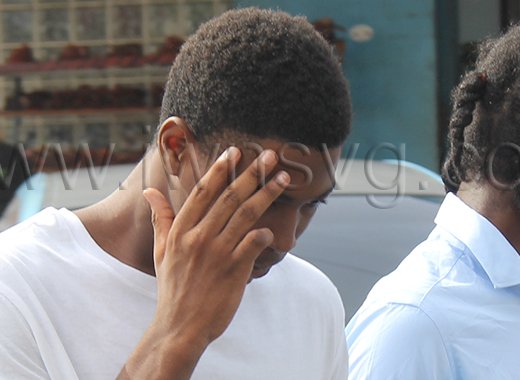 Teen killer Tyshaun Spring hides his face as he is led back to prison on July 24, 2026, to complete his sentence for murder. 