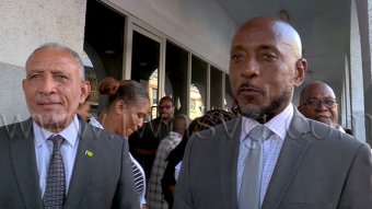Prime Minister Godwin Friday, left, and East Kingstown MP Dwight Fitzgerald Bramble, the respondents in the election petitions case, speak to iWitness News outside the High Court in Kingstown on Wednesday, Sept. 30, 2026.