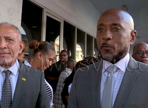 Prime Minister Godwin Friday, left, and East Kingstown MP Dwight Fitzgerald Bramble, the respondents in the election petitions case, speak to iWitness News outside the High Court in Kingstown on Wednesday, Sept. 30, 2026.