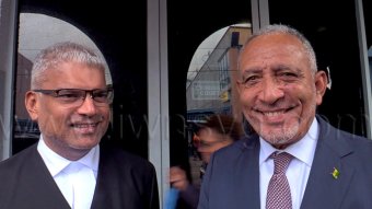 Prime Minister Godwin Friday, right, and Senior Counsel Anand Ramlogan, a member of the government’s legal team, outside the High Court in Kingstown on Monday, Sept. 28, 2026. 