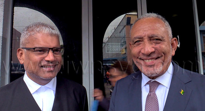 Prime Minister Godwin Friday, right, and Senior Counsel Anand Ramlogan, a member of the government’s legal team, outside the High Court in Kingstown on Monday, Sept. 28, 2026. 