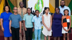 KCCU President Timothy Scott, Vice President Sabita Jacobs-Seymour, CEO Eronne Evans and the scholarship recipients. 