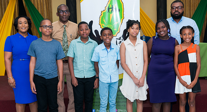 KCCU President Timothy Scott, Vice President Sabita Jacobs-Seymour, CEO Eronne Evans and the scholarship recipients. 