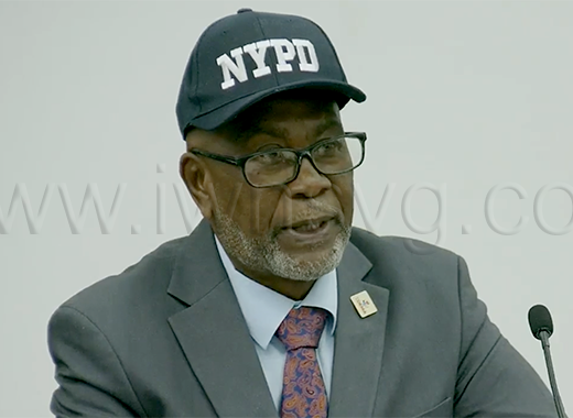 Deputy Prime Minister and National Security Minister St. Clair Leacock wears an "NYPD" cap as he speaks in Parliament on Aug. 27, 2026.