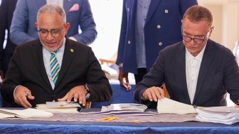 Prime Minister of St. Vincent and the Grenadines, Godwin Friday, left, and Global Ports Holding founder and chief executive Mehmet Kutman at the signing ceremony in Kingstown on Monday, Oct. 26, 2026.