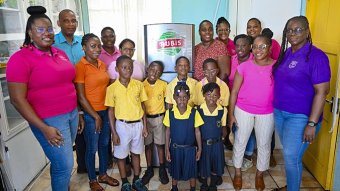 Elroy Edwards, country representative of Rubis, presents a brand-new refrigerator to Nicole Parris on behalf of Lowmans Leeward Anglican Primary School, as part of Rubis's continued commitment to supporting the communities it serves.