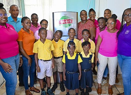 Elroy Edwards, country representative of Rubis, presents a brand-new refrigerator to Nicole Parris on behalf of Lowmans Leeward Anglican Primary School, as part of Rubis's continued commitment to supporting the communities it serves.