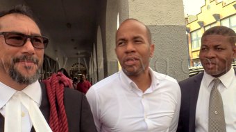 Senior Counsel Stuart Young, left, and his clients, petitioners Luke Browne, centre, and Carlos Williams, speak to the media outside the High Court in Kingstown on Thursday, Oct. 1, 2026.