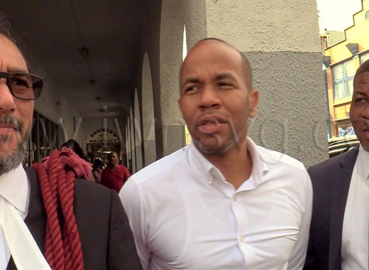 Senior Counsel Stuart Young, left, and his clients, petitioners Luke Browne, centre, and Carlos Williams, speak to the media outside the High Court in Kingstown on Thursday, Oct. 1, 2026.